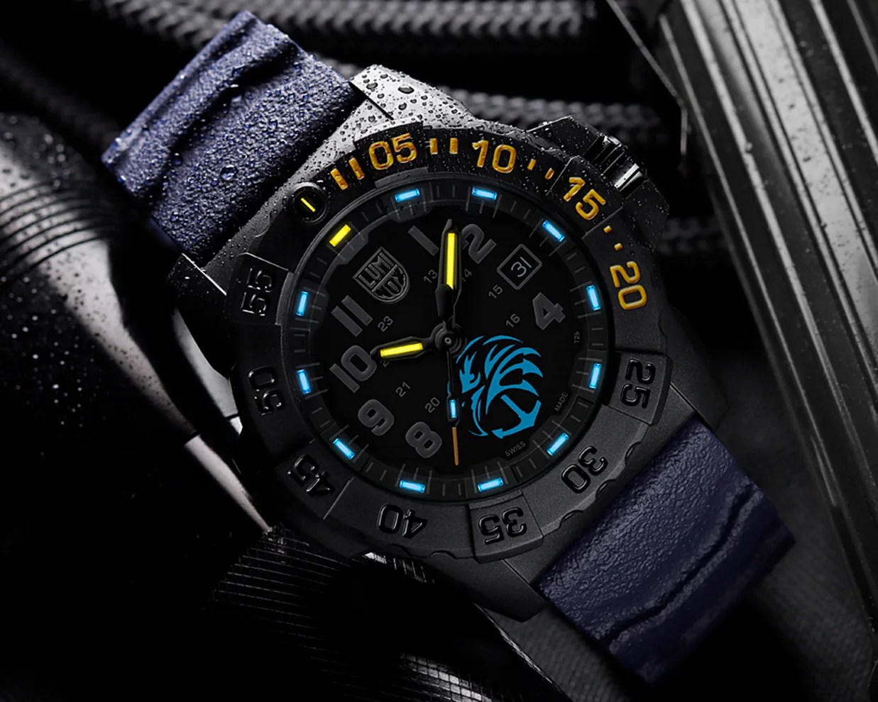 Black tactical wristwatch with yellow hands, blue glowing hour markers, and a blue lion logo on the dial, with a textured blue strap.