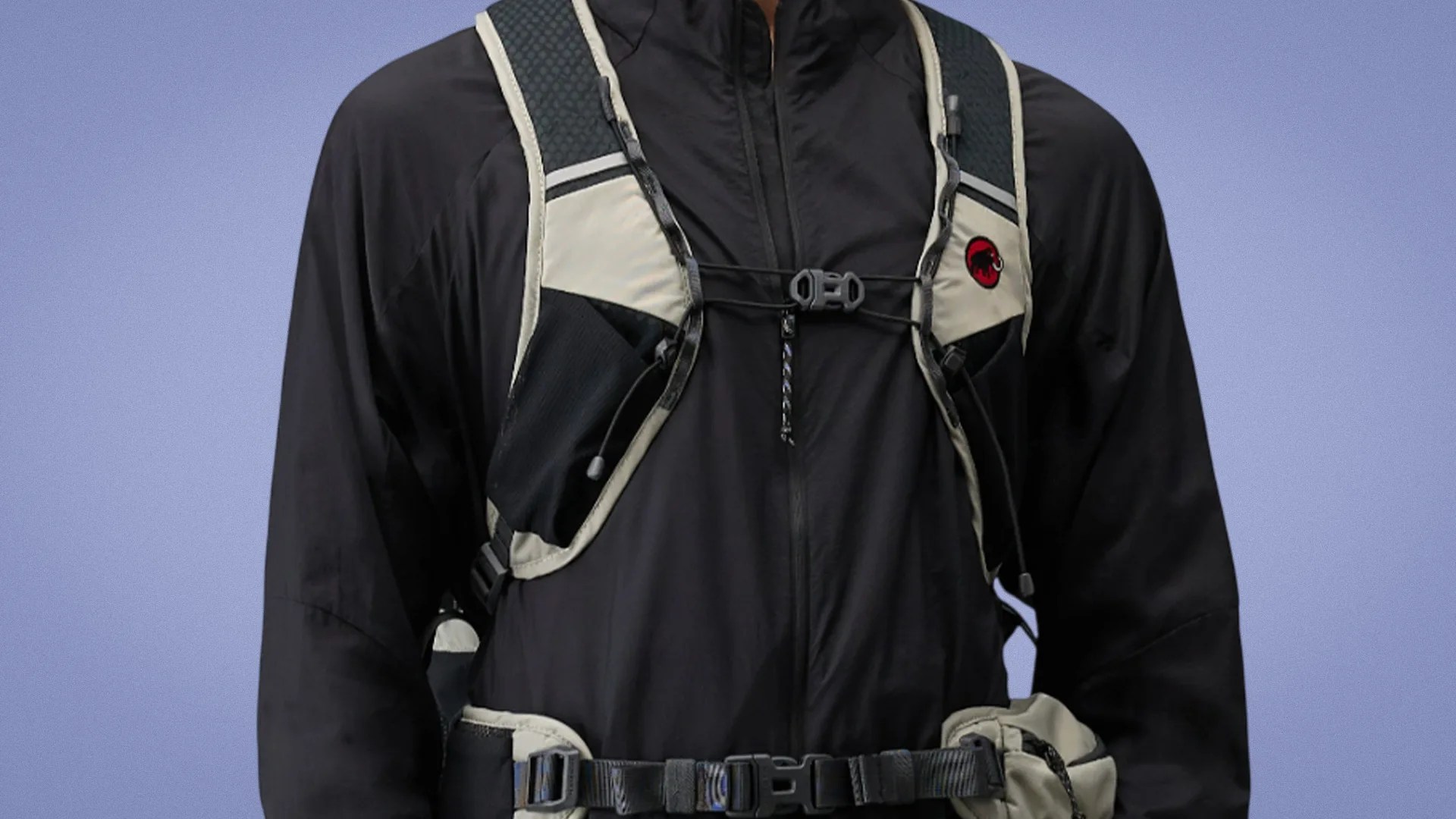 Black and beige hiking vest with adjustable straps and a red mammoth logo on the chest.