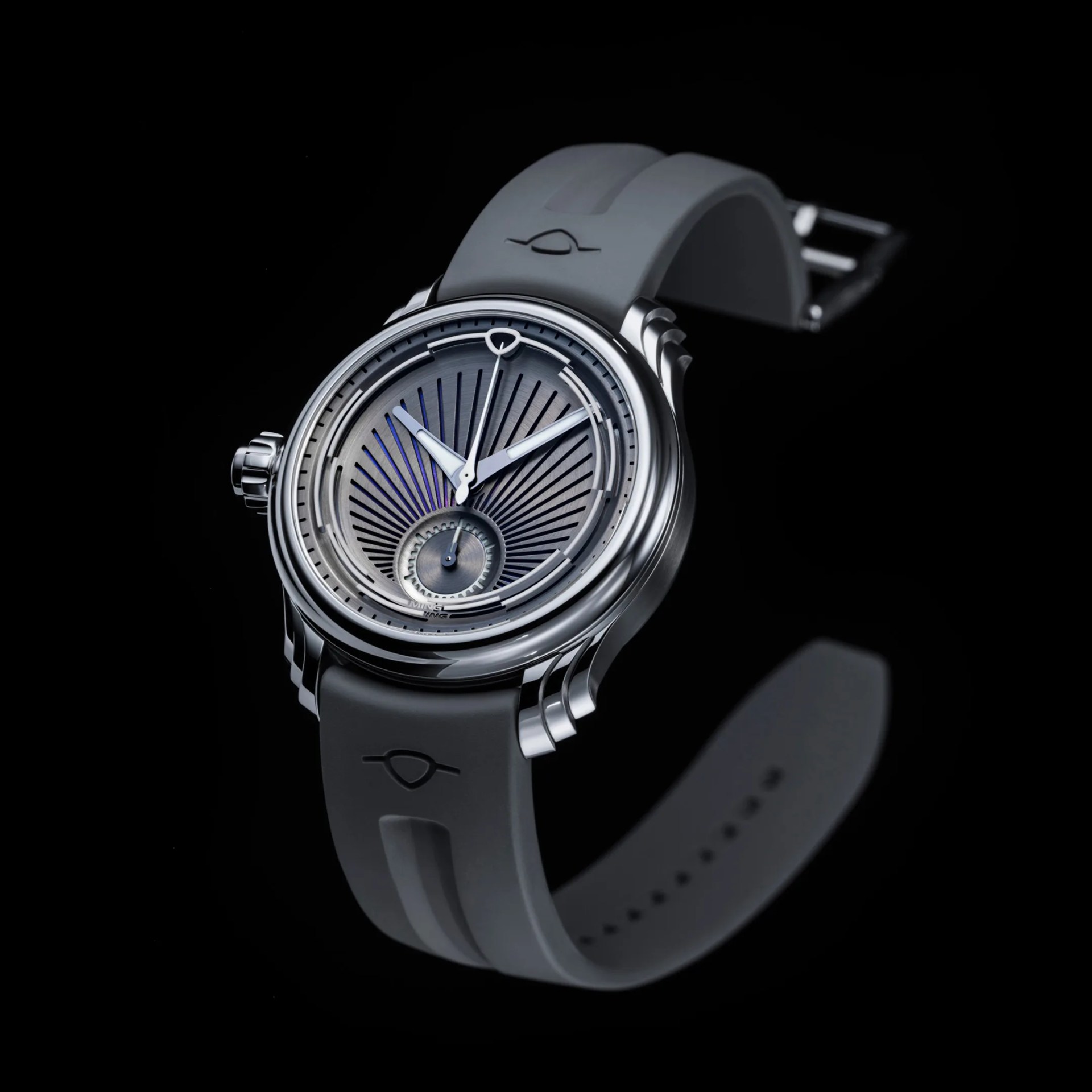 Silver wristwatch with a textured gray dial, blue accents, and a gray rubber strap on a black background.