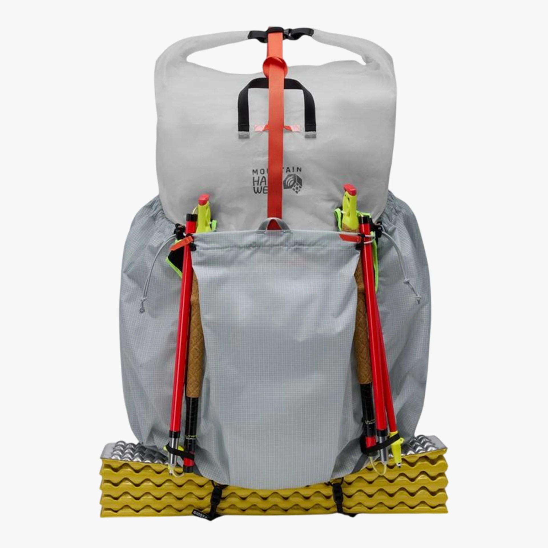 Gray Mountain Hardwear backpack with red trekking poles and yellow foam sleeping pad attached.
