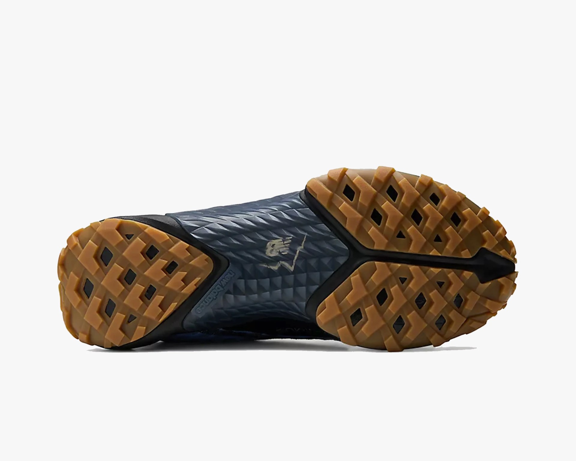 Sole of a black and gum rubber New Balance shoe with textured grip and Nike logo in the center.