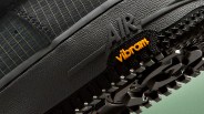 Close-up of a black shoe sole with "AIR" embossed and an orange "vibram" logo on the textured tread.