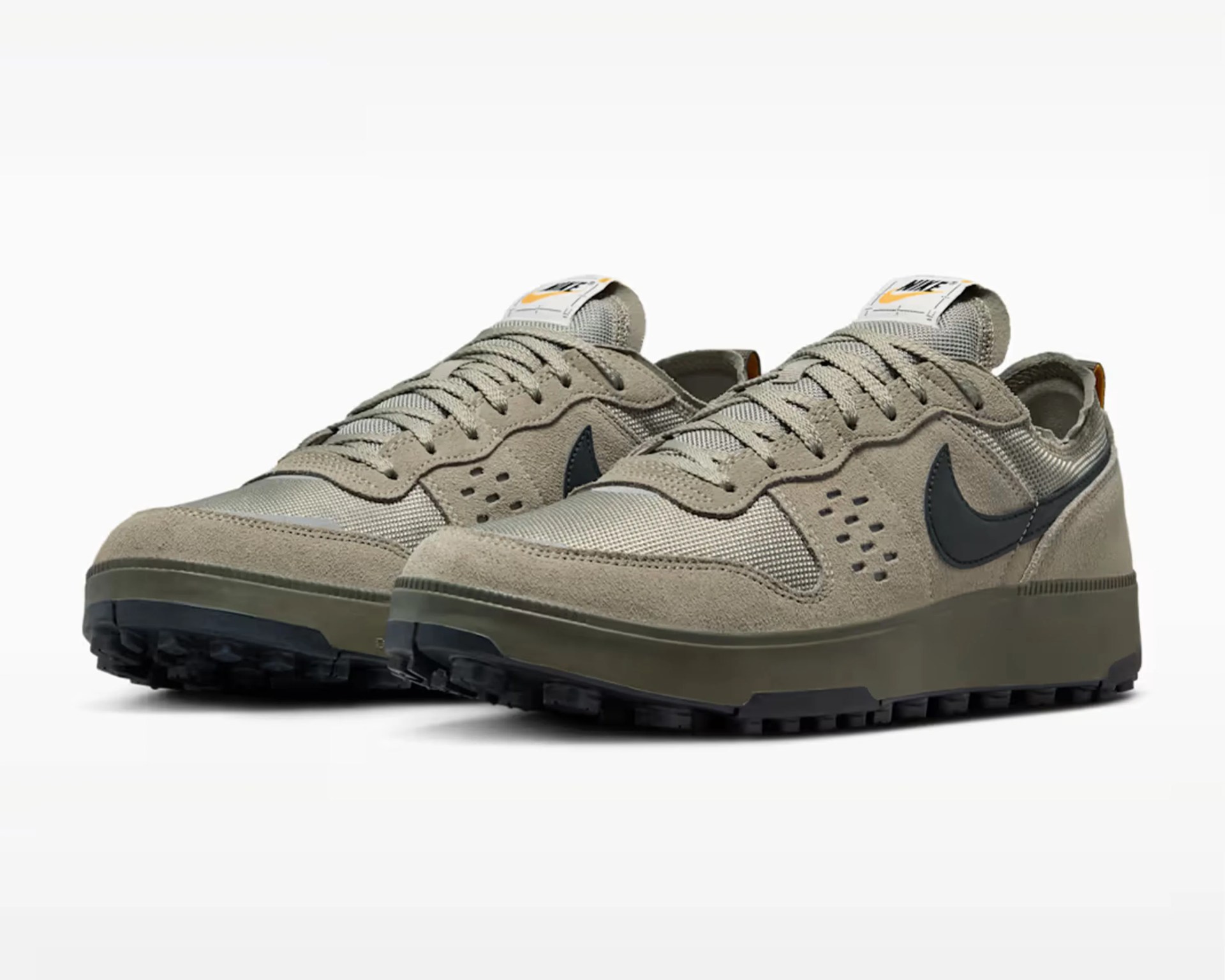 Pair of beige and olive green Nike sneakers with black swoosh logos and mesh fabric panels.
