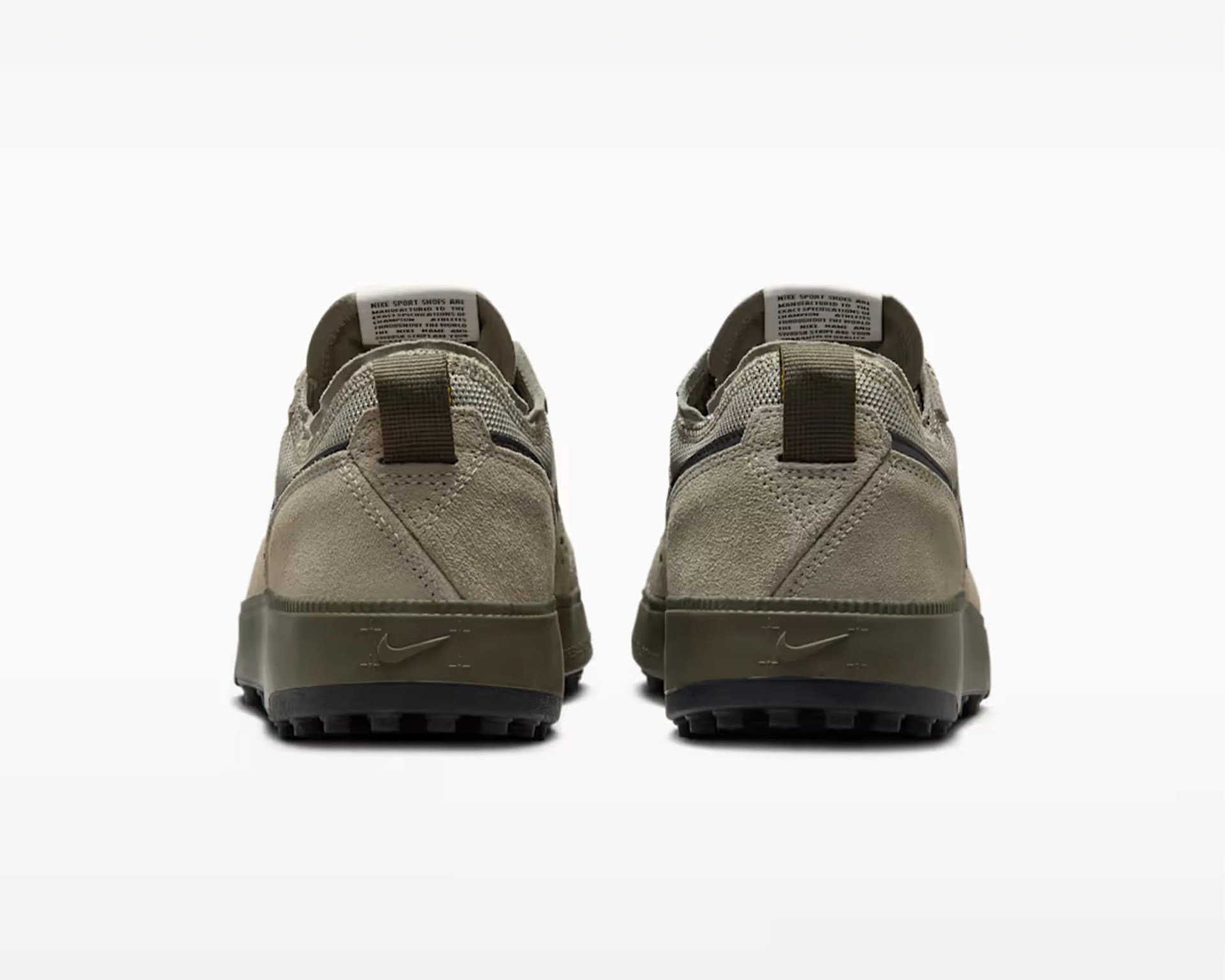 Pair of beige and olive green Nike sneakers shown from the back with textured soles and pull tabs.