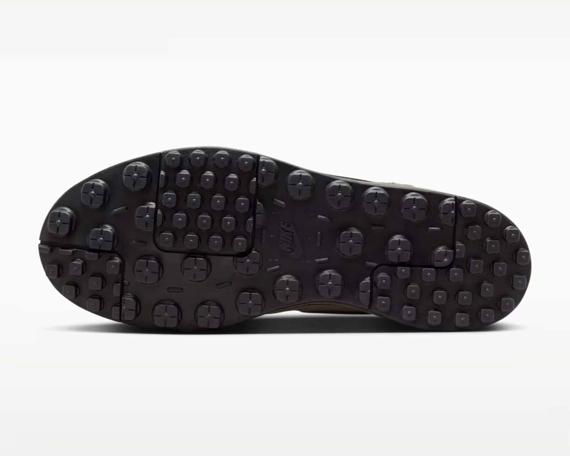 Black rubber outsole with circular and square traction studs and a Nike logo in the center.