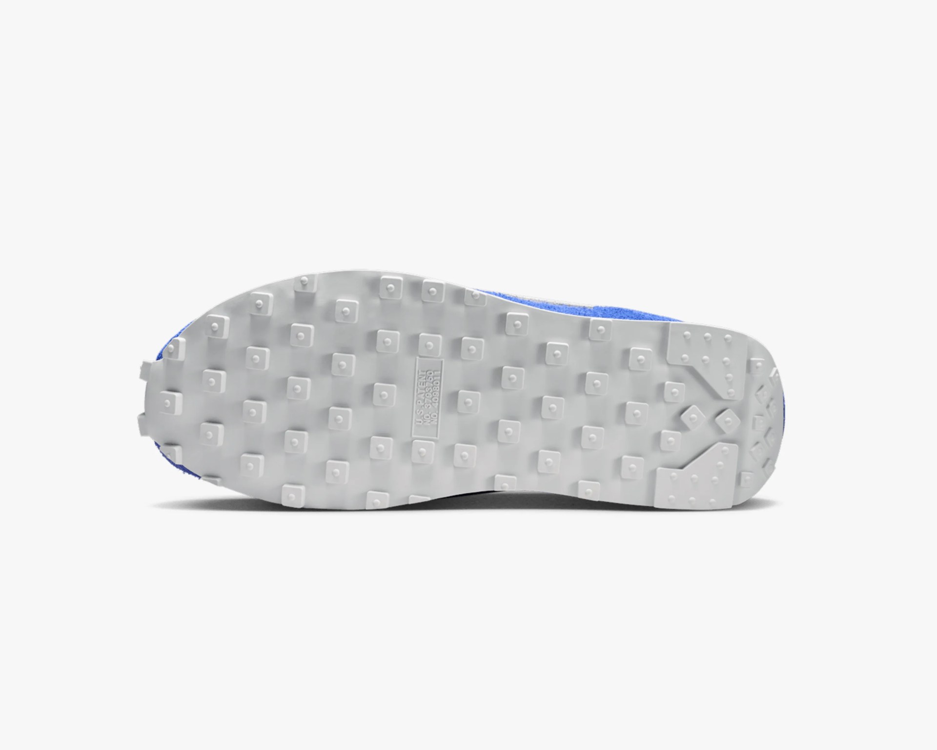 White rubber shoe sole with square and round traction studs and patent number embossed in the center.