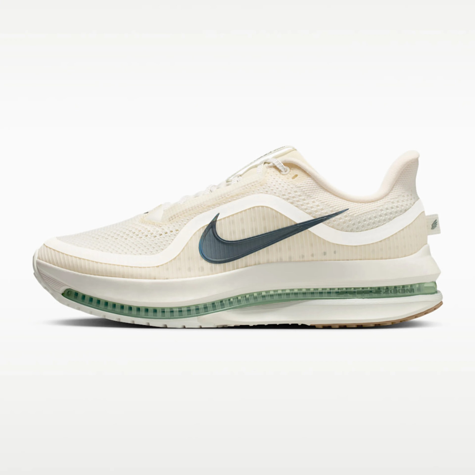 Cream-colored Nike running shoe with a translucent green sole and dark blue swoosh logo.