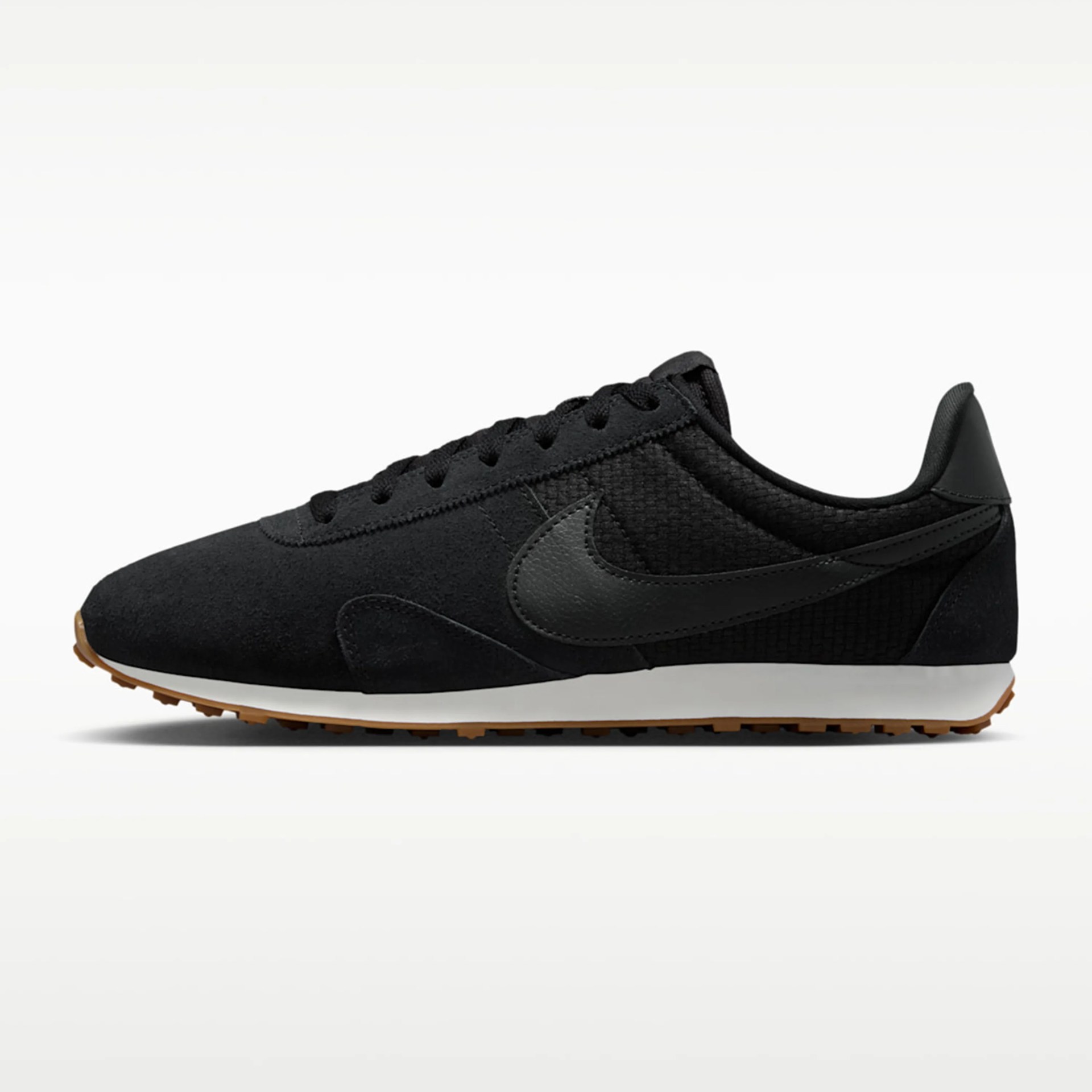 Black Nike sneaker with leather swoosh, white midsole, and gum rubber outsole on a white background.