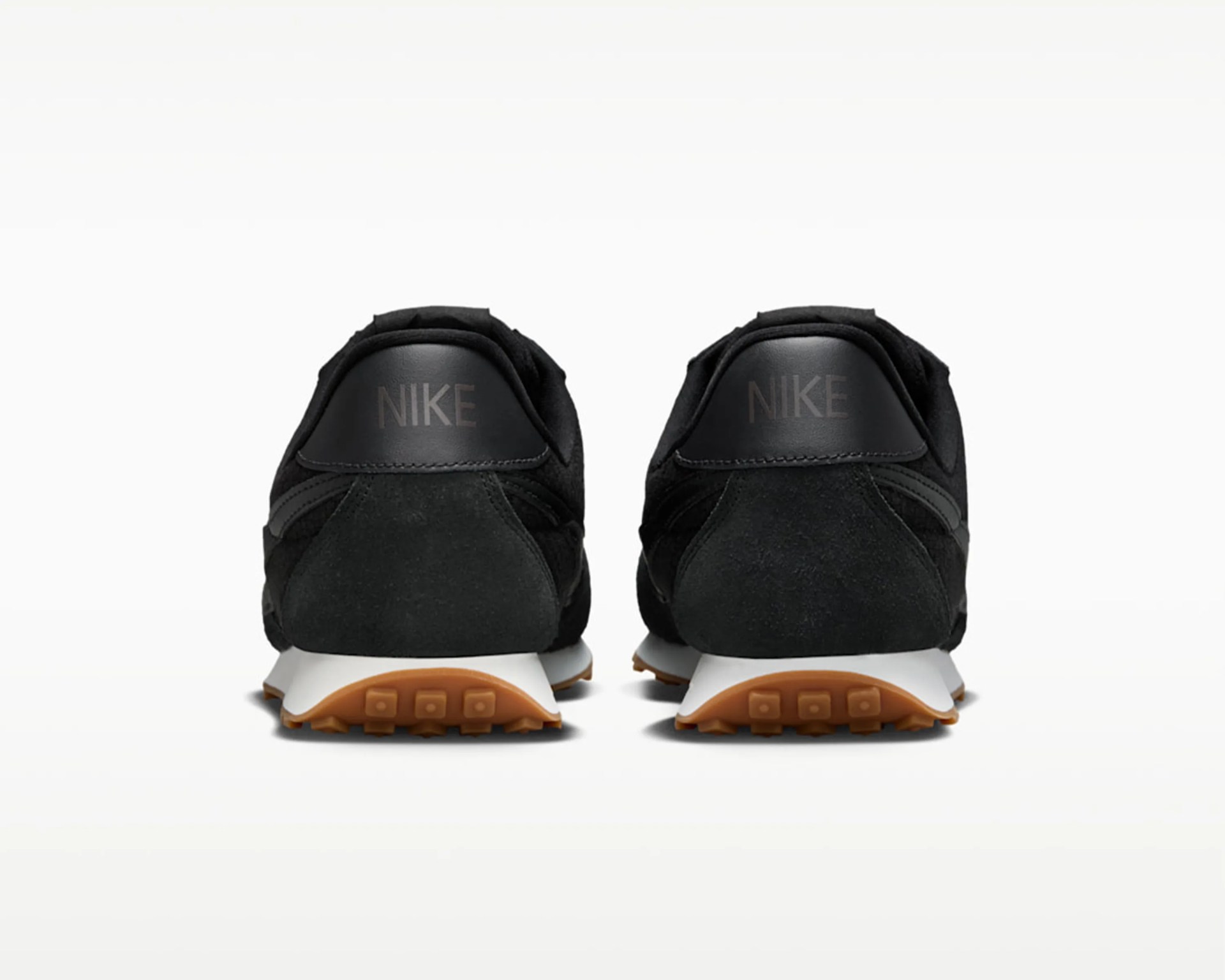 Pair of black Nike sneakers with white midsoles and gum rubber outsoles shown from the back.