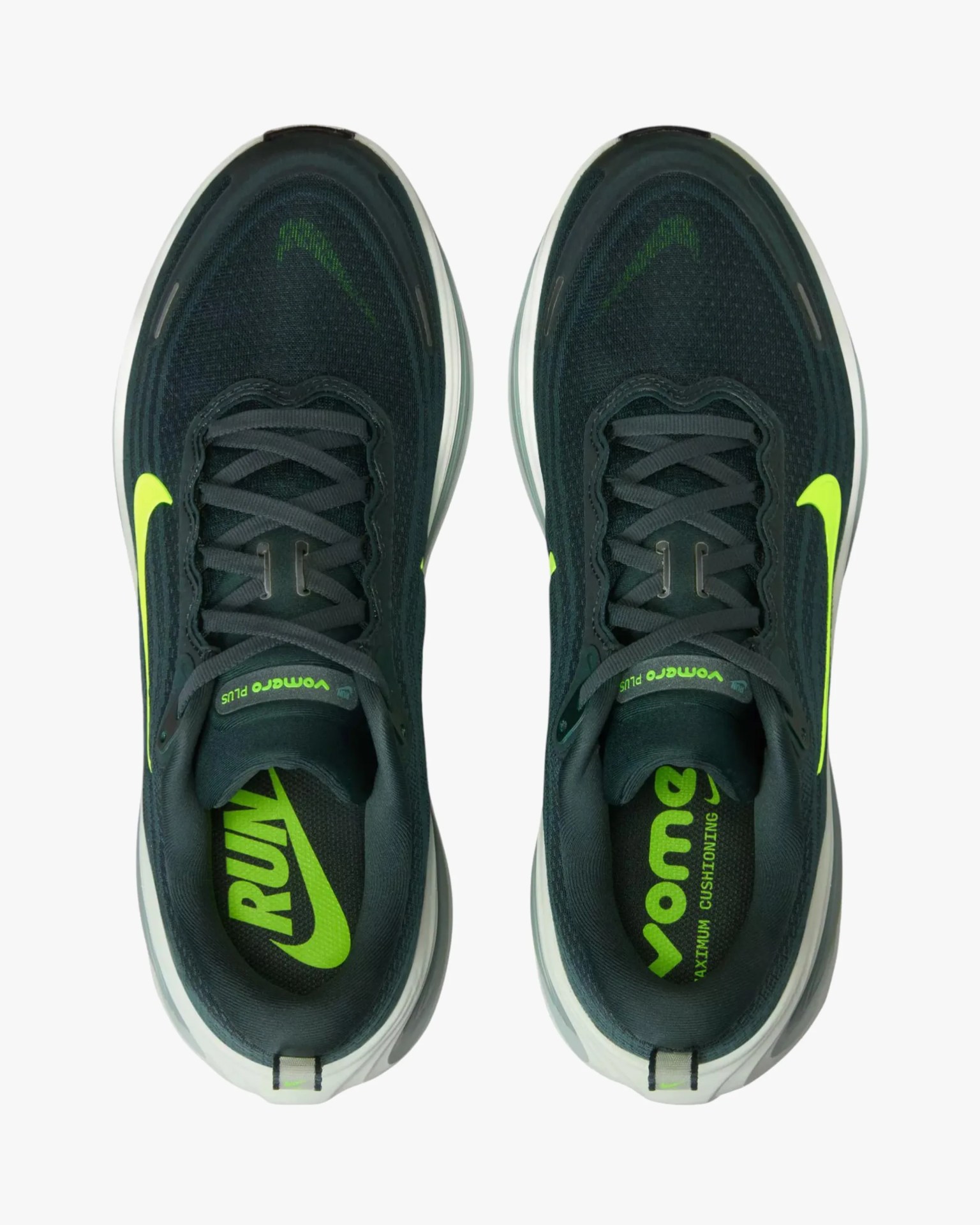 Pair of black and neon green Nike running shoes viewed from above, showing laces and insoles with branding.