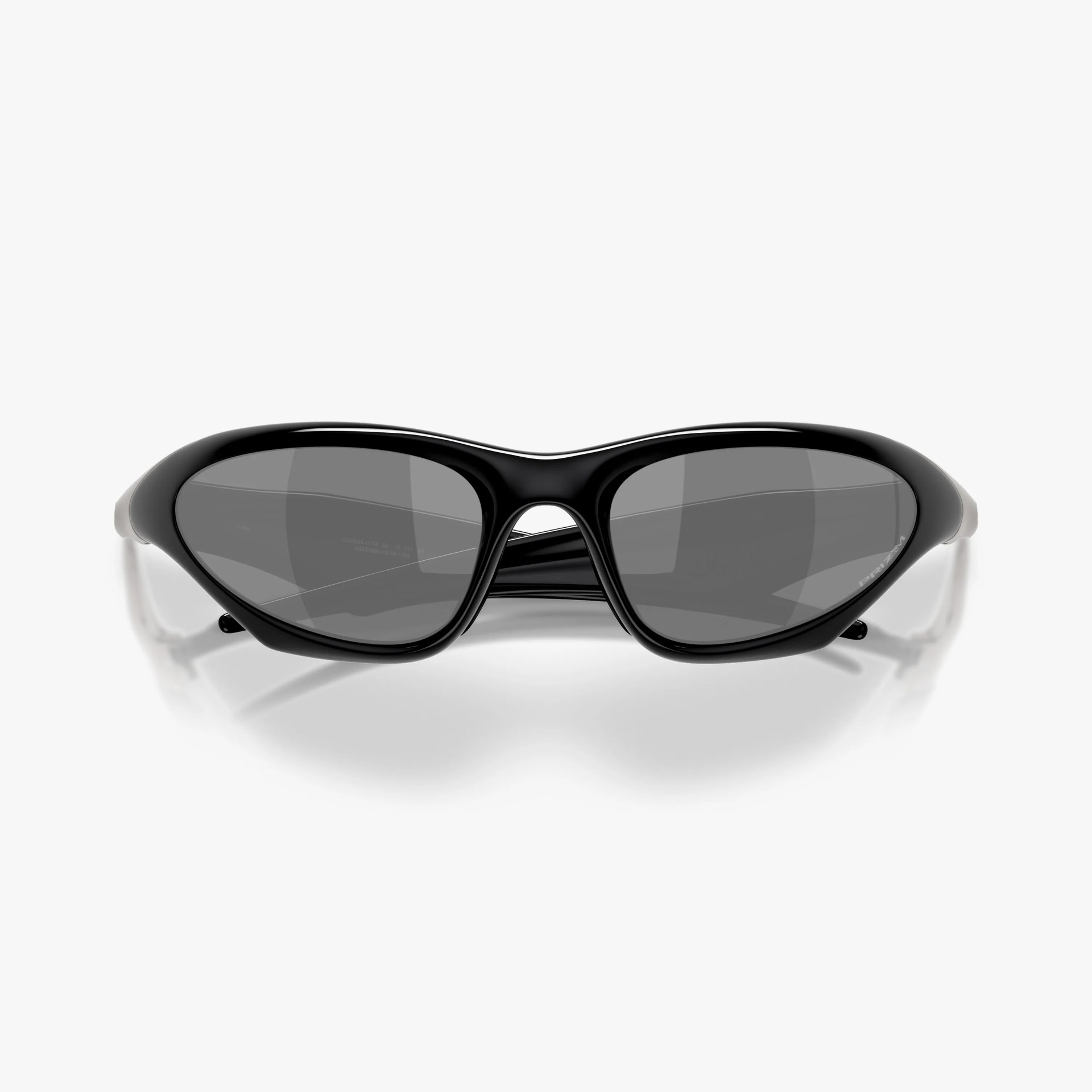 Black oval-shaped sunglasses with dark tinted lenses and a glossy frame on a white background.