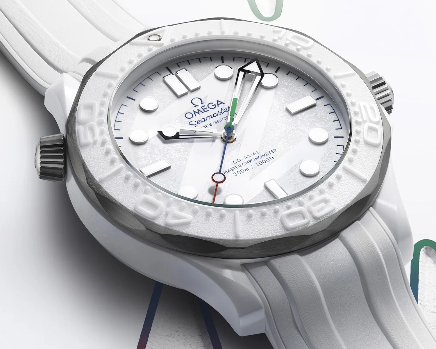 White Omega Seamaster wristwatch with textured dial, white bezel, and white rubber strap.