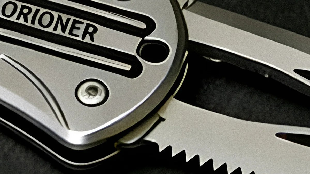 Close-up of a silver multi-tool with a partially serrated blade and the word "ORIONER" on the handle.