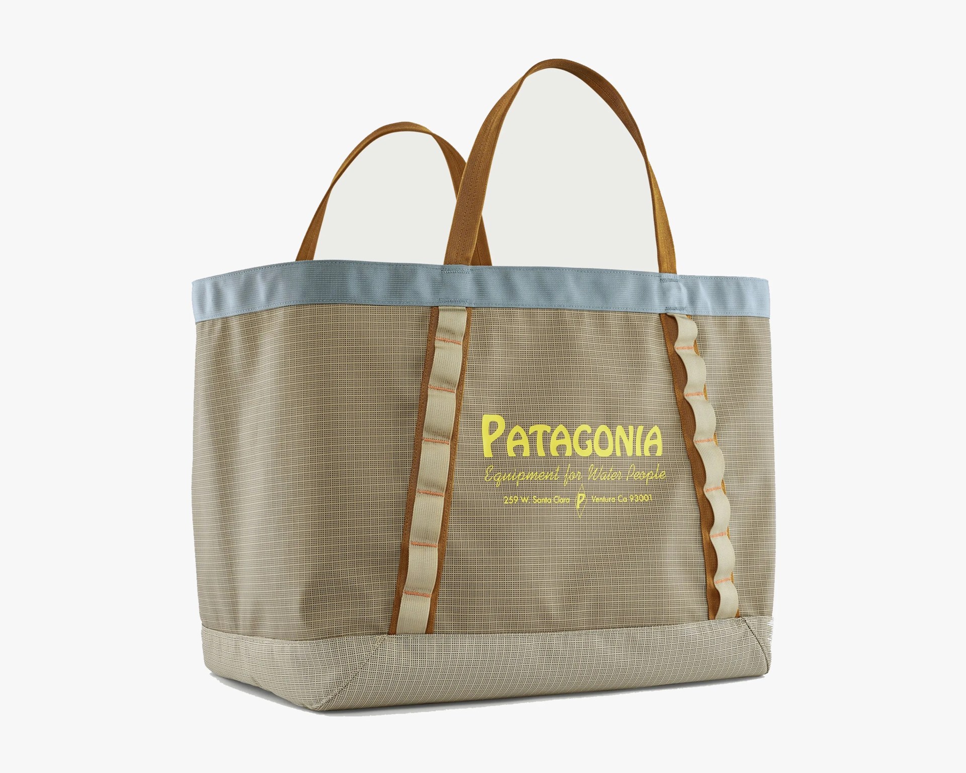 Beige Patagonia tote bag with light blue trim, brown handles, and yellow logo text on front.