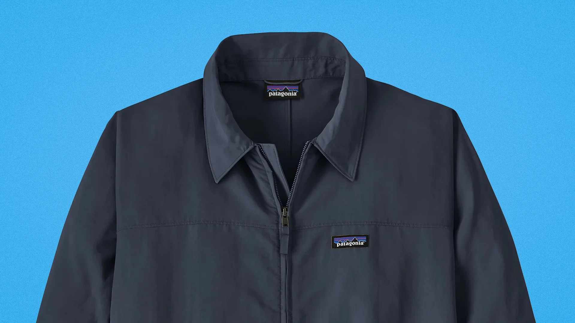 Navy blue Patagonia zip-up jacket with collar and logo patch on chest.
