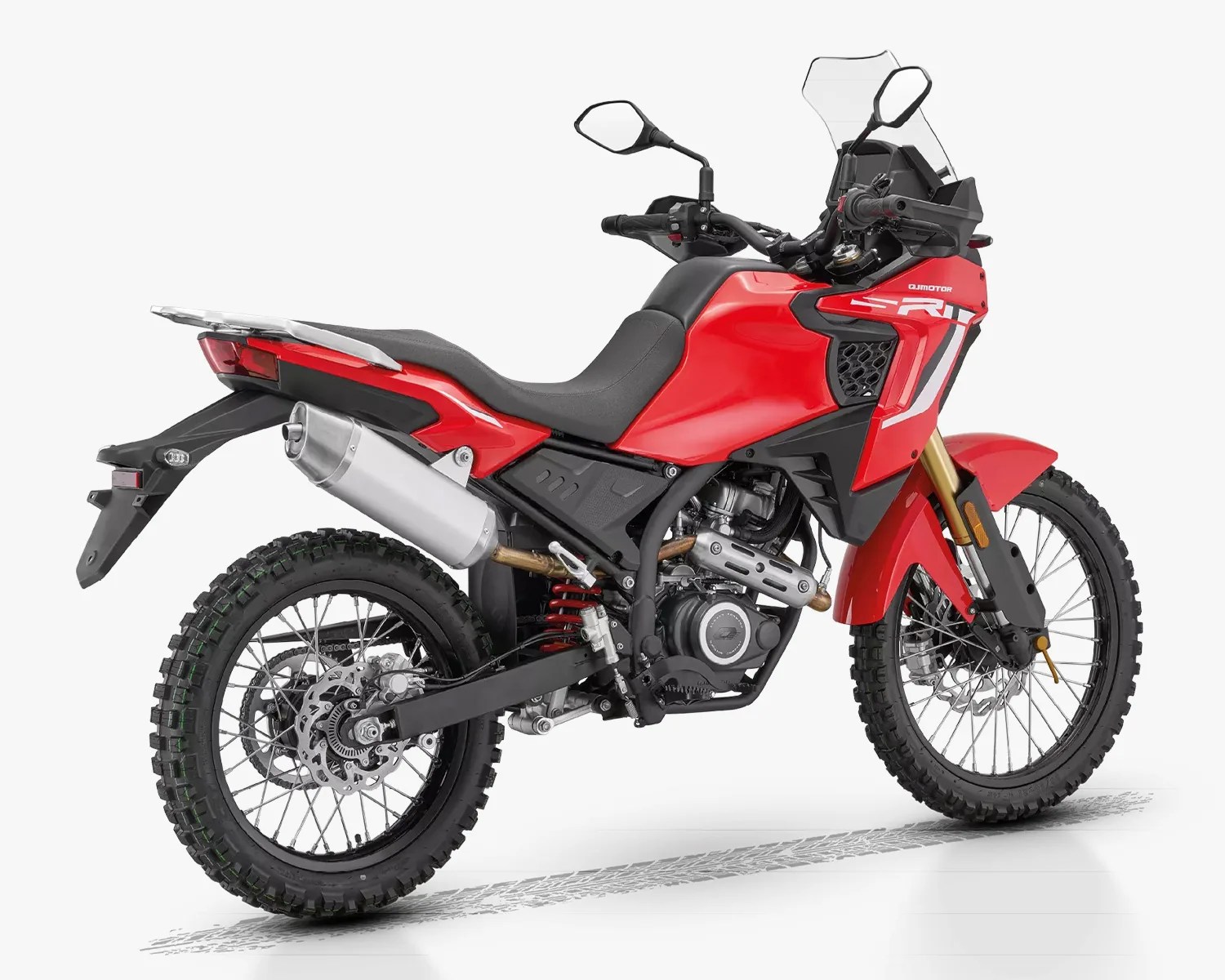 Red and black dual-sport motorcycle with knobby tires and a silver exhaust on a white background.