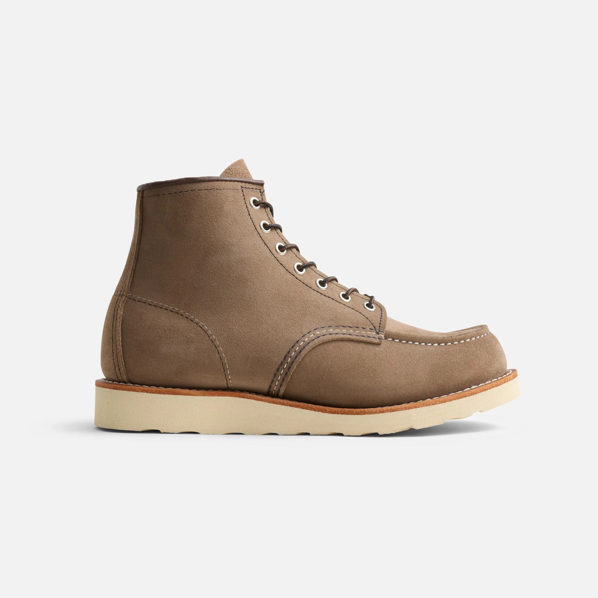 Tan suede moc toe boot with white stitching and cream-colored sole on a white background.