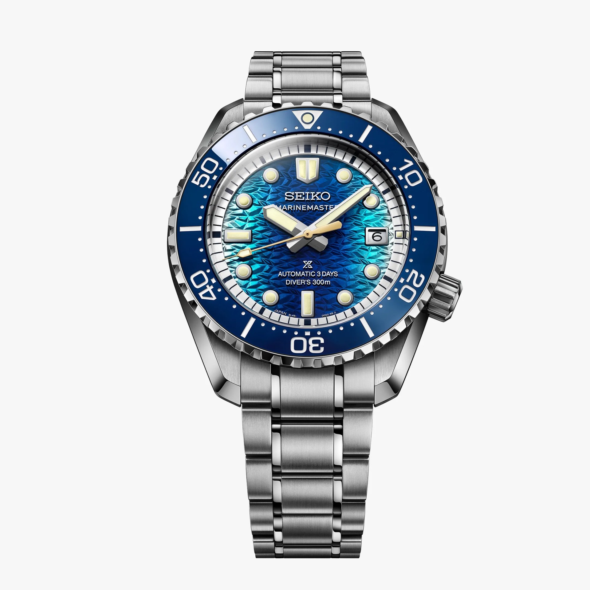 Seiko Marinemaster diver's watch with blue textured dial, blue bezel, and stainless steel bracelet.