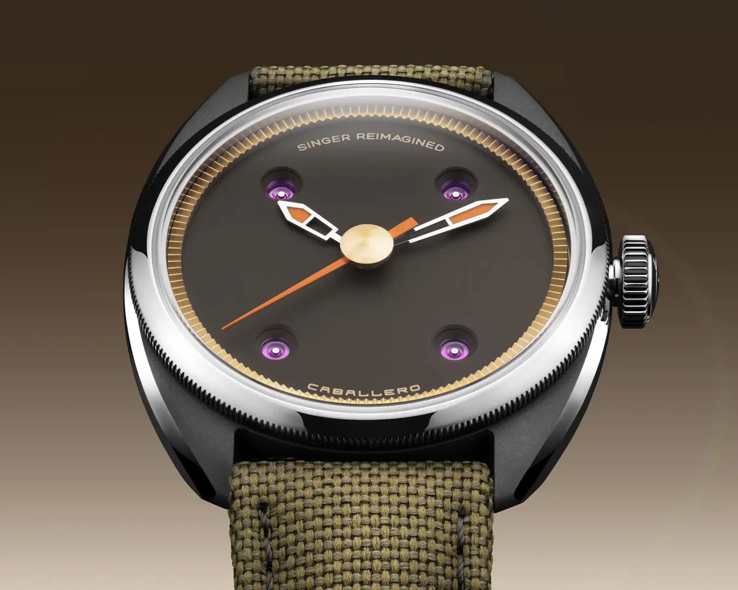 Round wristwatch with black dial, orange and white hands, purple accents, and olive green woven strap.