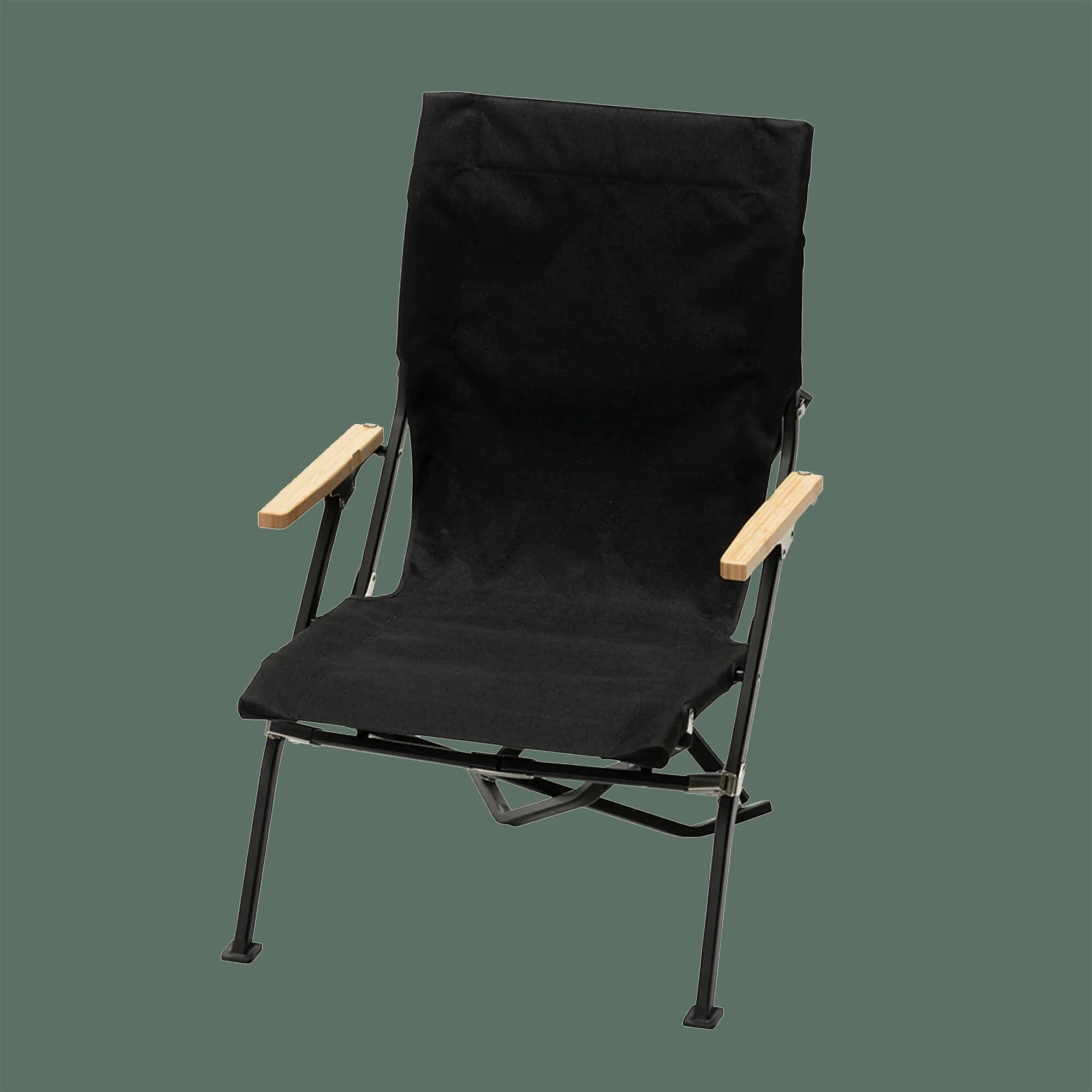 Black fabric folding chair with wooden armrests and metal frame on a green background.