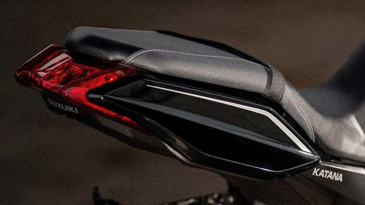 Rear section of a black Suzuki Katana motorcycle with a gray seat and red tail light.