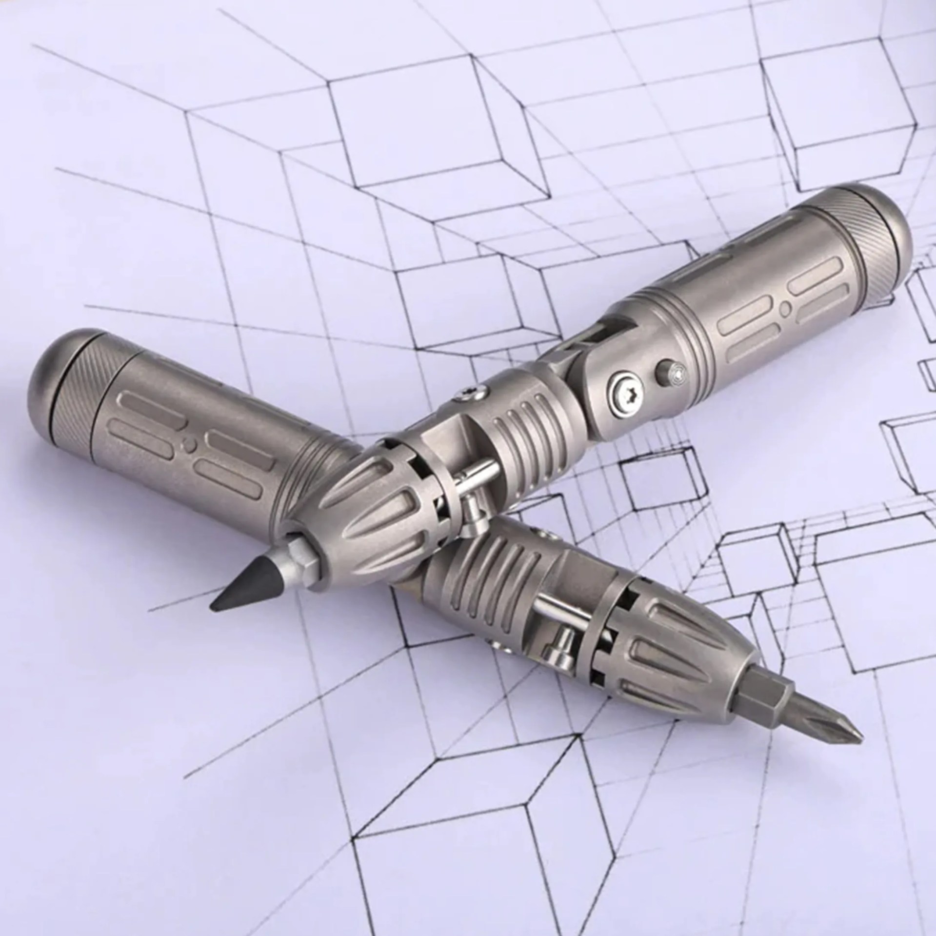 Two metallic multi-tool pens with screwdriver and pencil tips on a geometric cube sketch background.