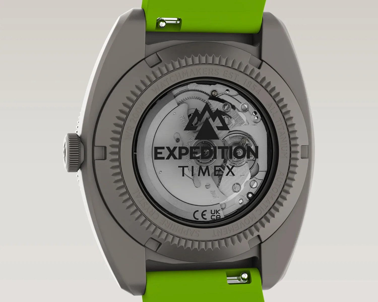 Back of a titanium Timex Expedition watch with visible automatic movement and green strap.