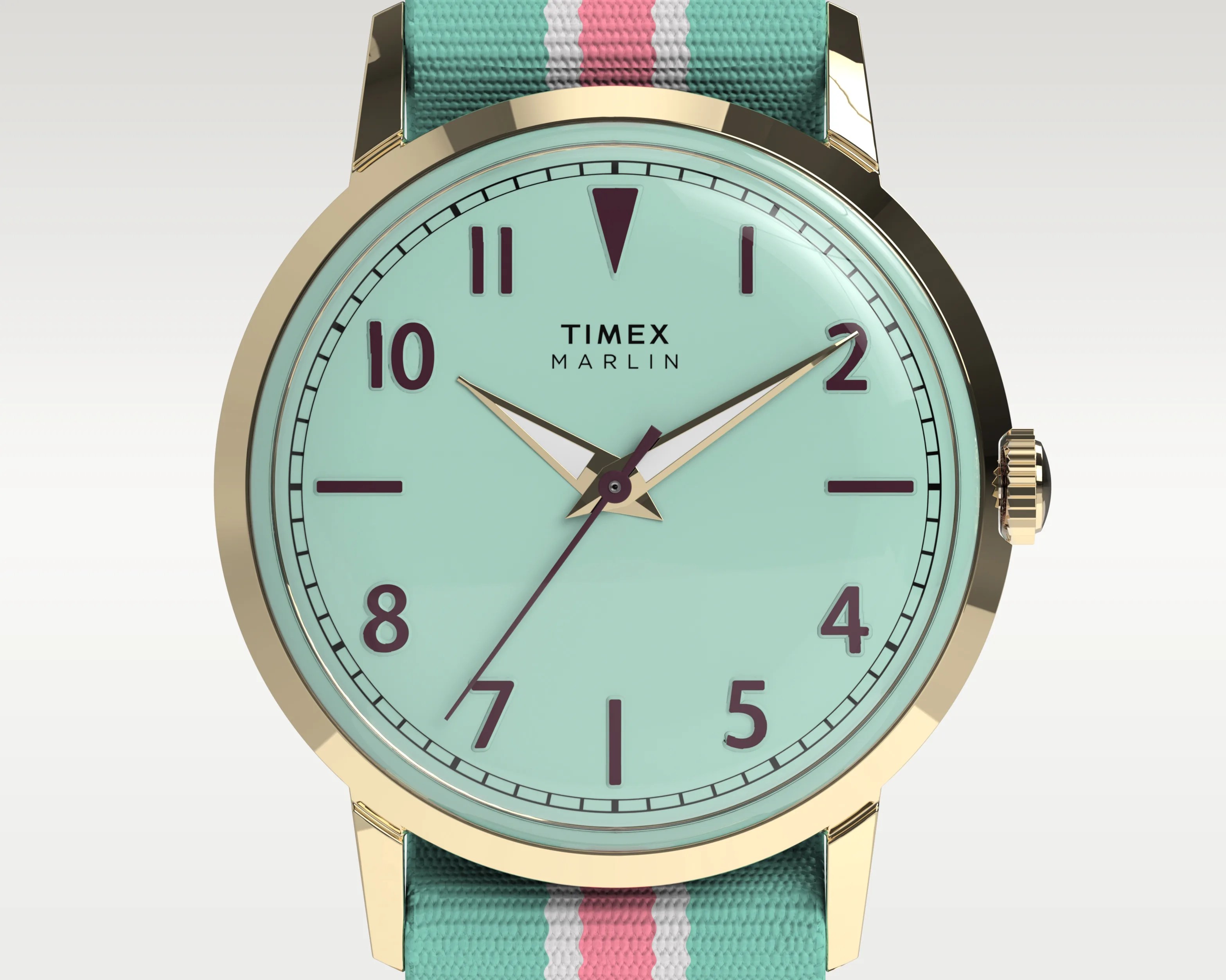 Timex Marlin watch with gold-tone case, mint green dial, purple numerals, and teal fabric strap with pink and white stripes.