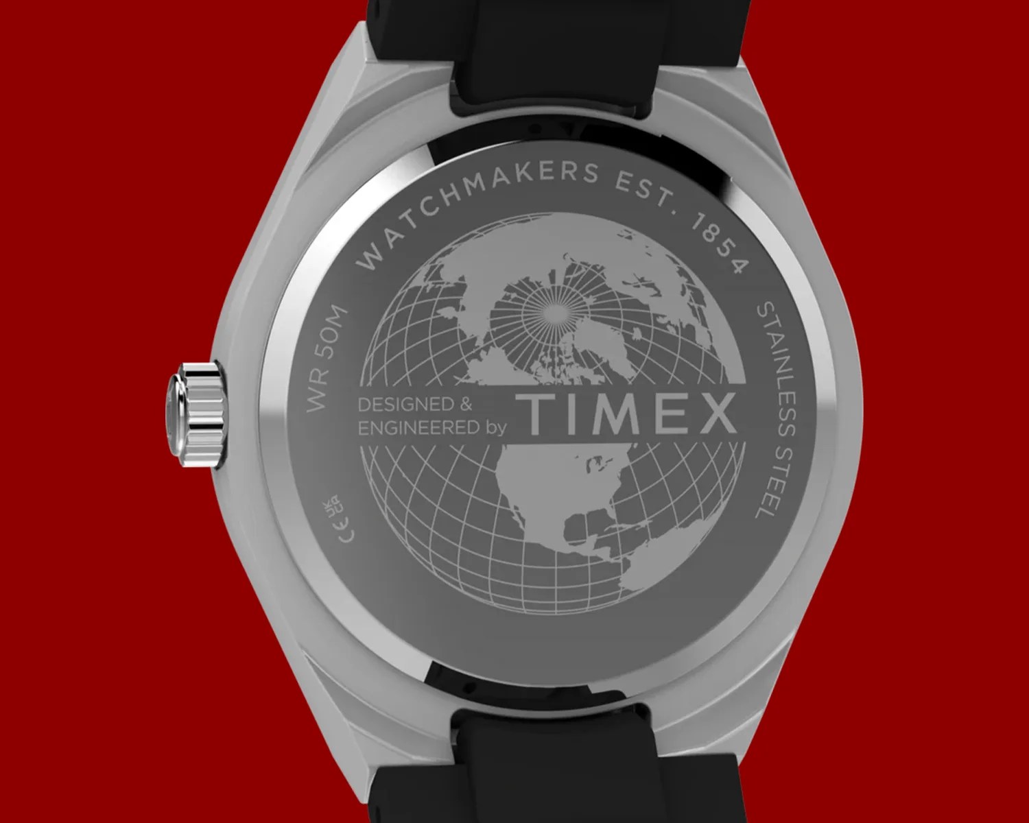 Back of a stainless steel Timex watch with black strap, engraved with a globe and text "WATCHMAKERS EST. 1854".