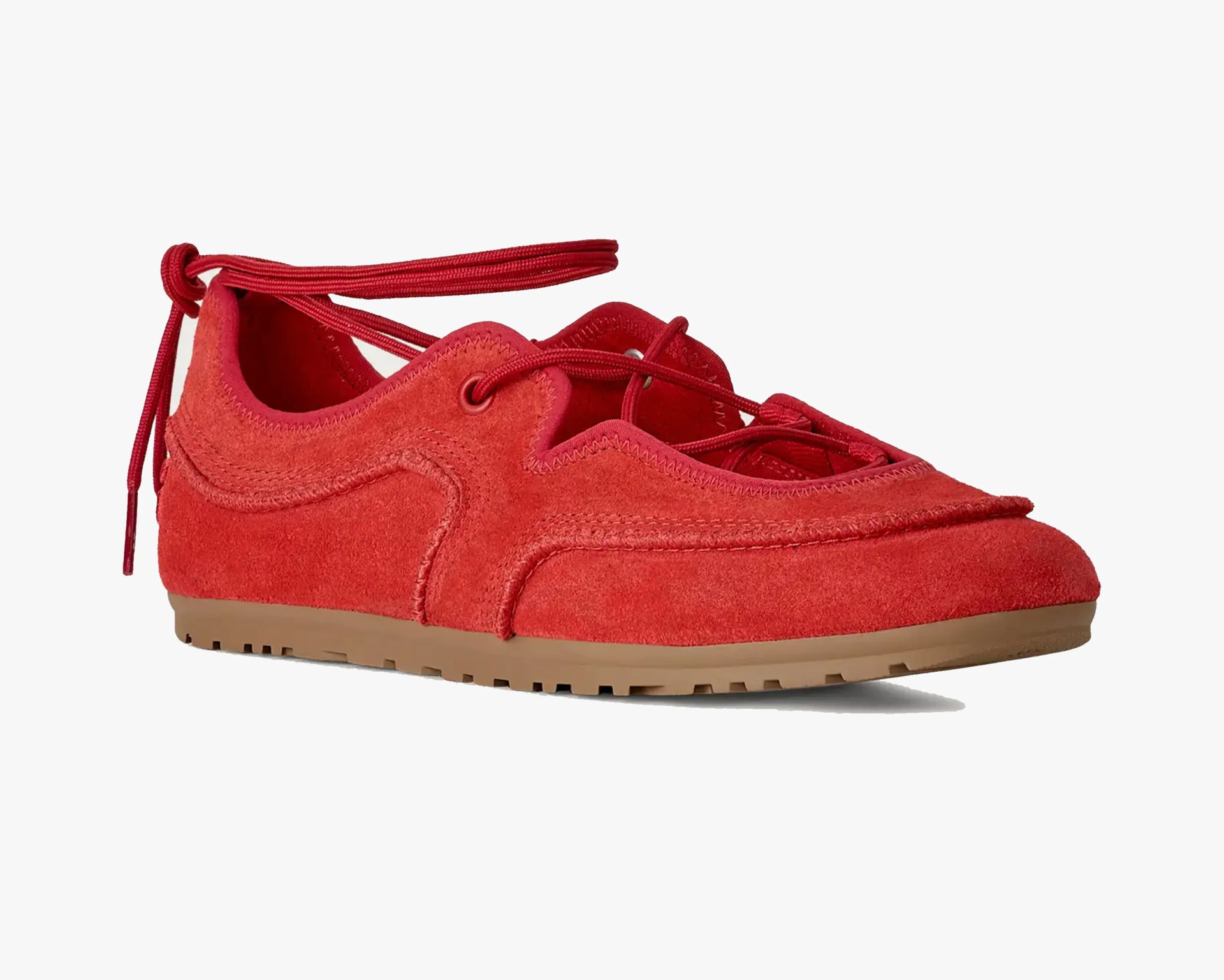 Red suede sneaker with gum sole and red laces tied at the back.