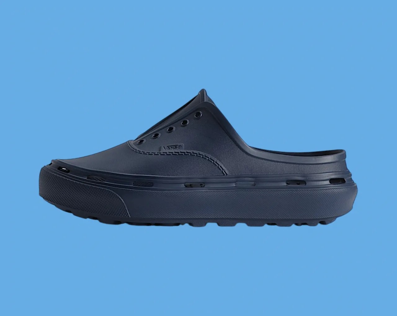 Navy blue slip-on clog with ventilation holes and thick rubber sole against a blue background.