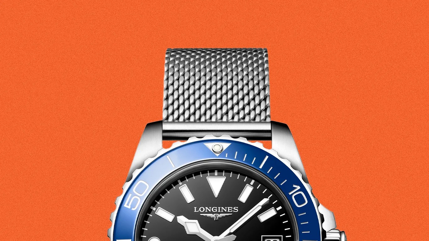 Silver mesh strap watch with black dial, blue bezel, and white markers by Longines.