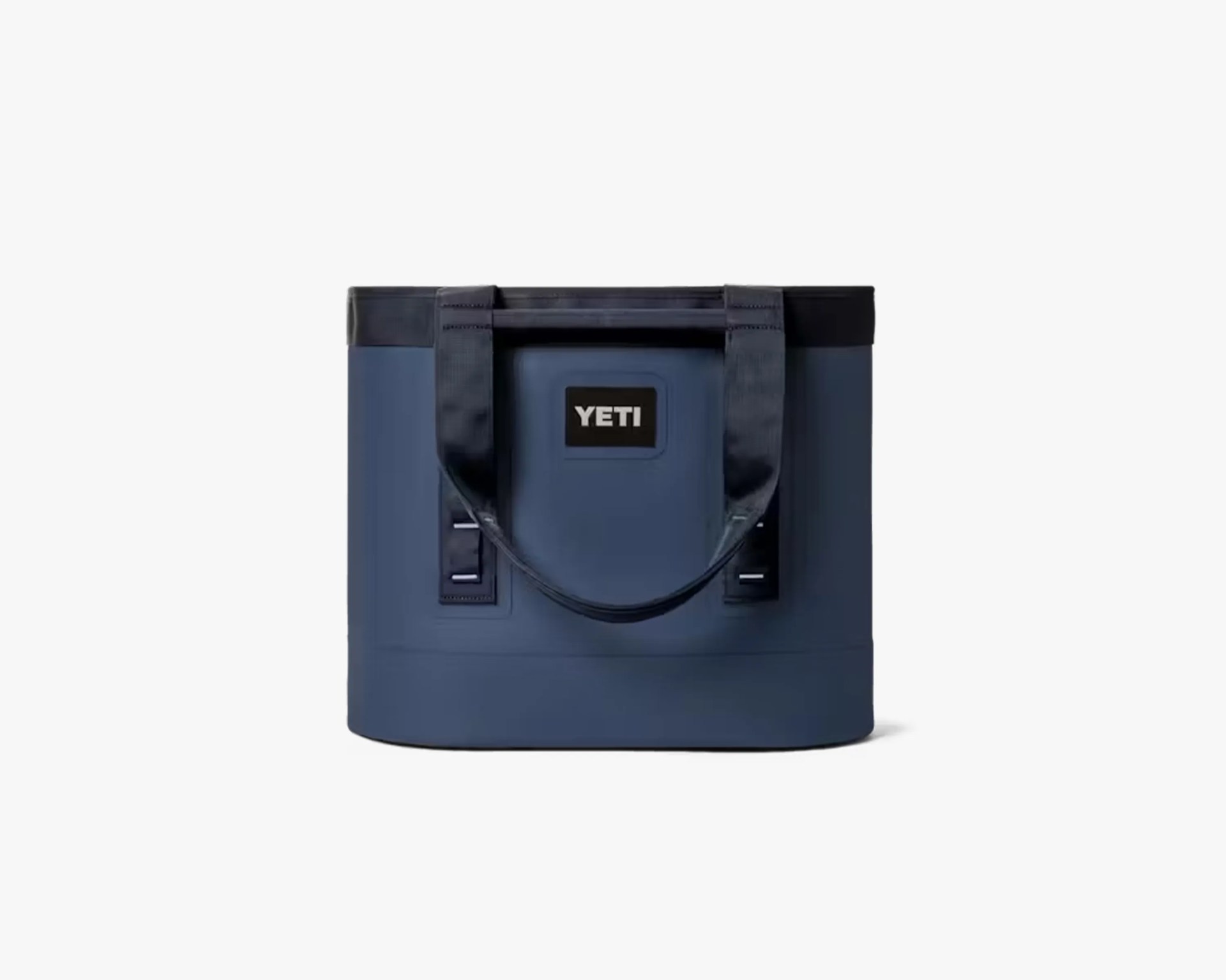 Navy blue YETI soft cooler bag with black handles and logo patch on front.
