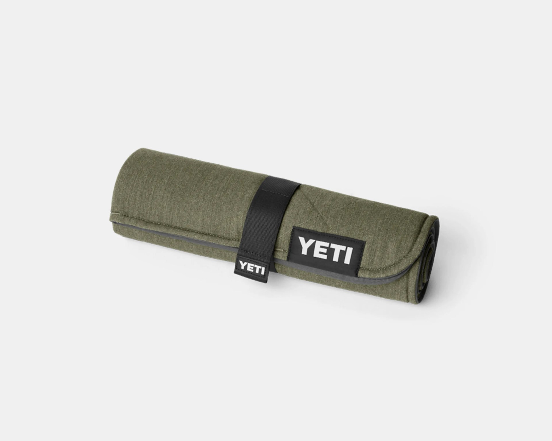 Olive green rolled-up YETI branded fabric pouch secured with a black strap.