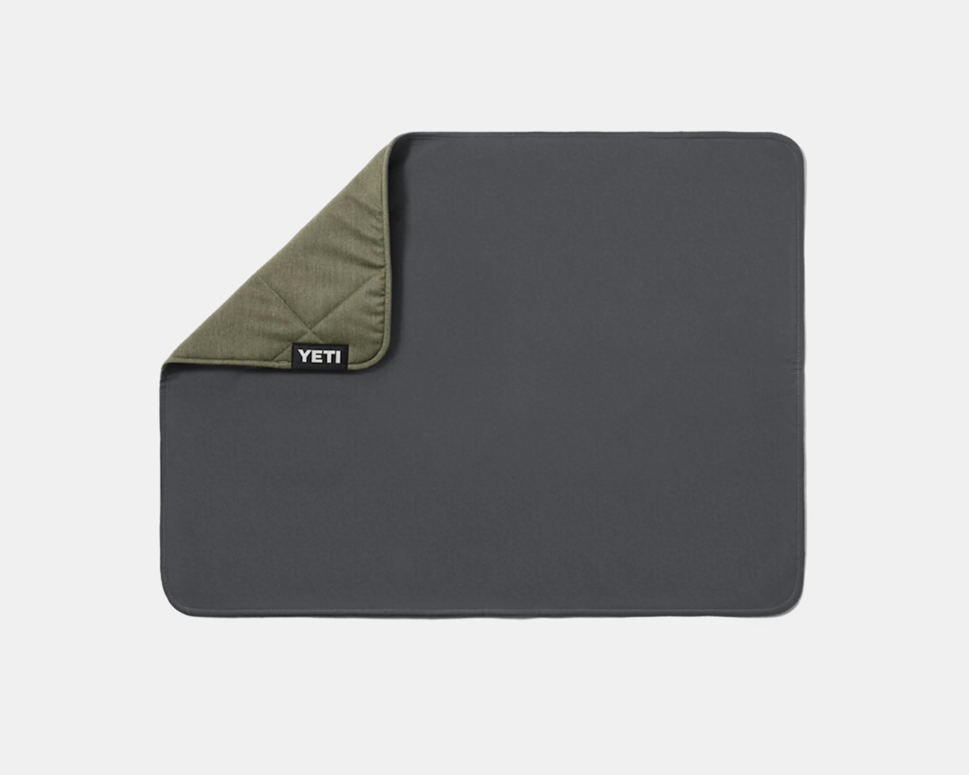 Rectangular dark gray and olive green YETI branded blanket with one corner folded over.