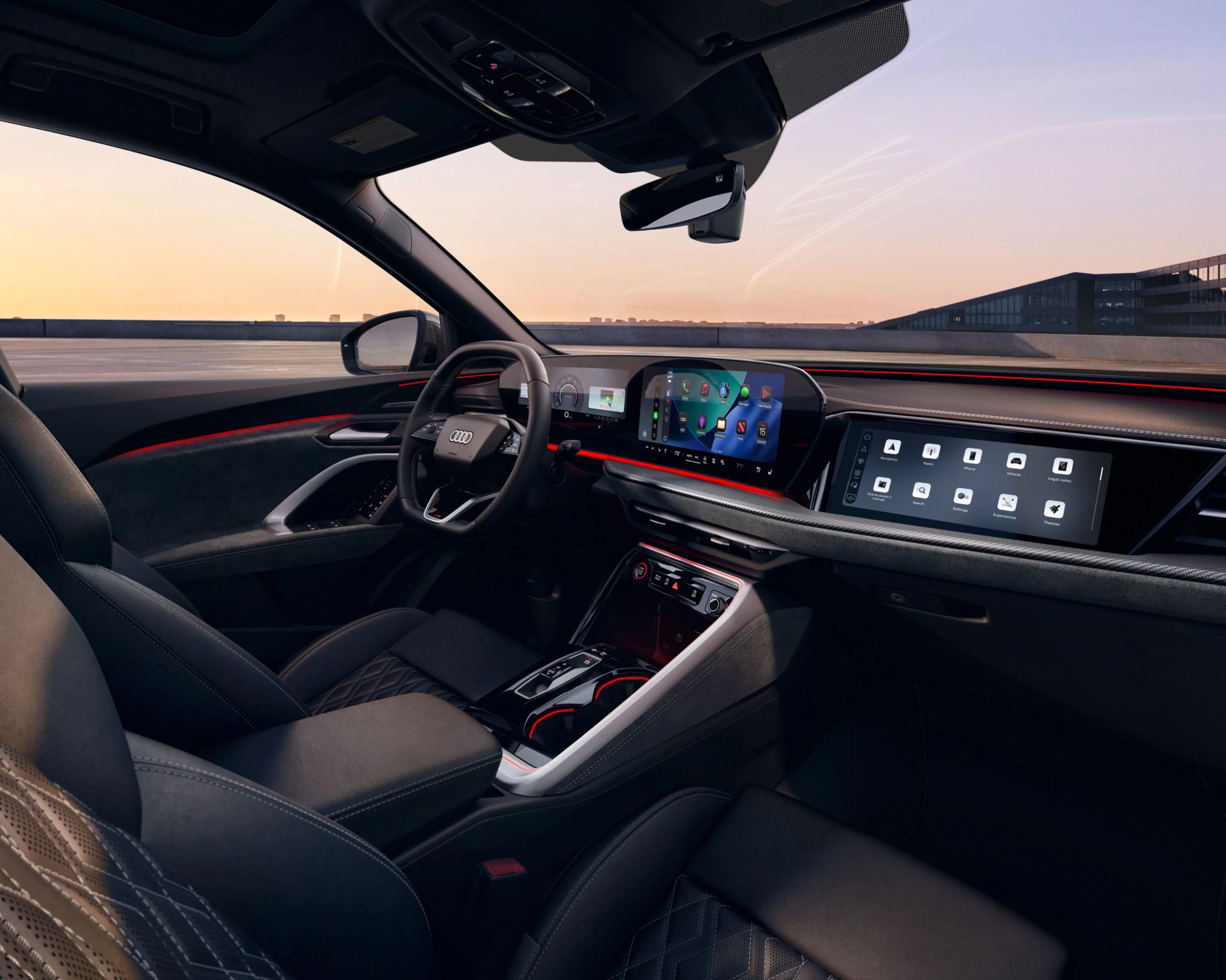 Audi car interior with black leather seats, digital dashboard, and red ambient lighting at sunset.