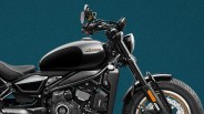Black and silver CLE motorcycle with round headlight and front disc brake against teal background.
