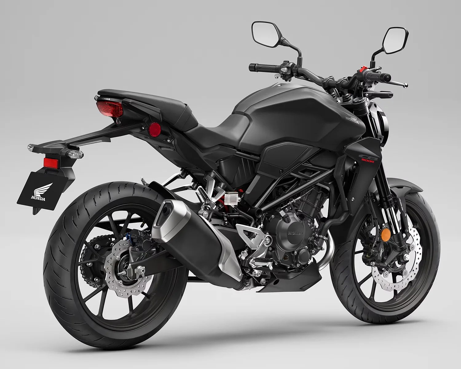 Matte black Honda CB300R motorcycle with dual disc brakes and a single exhaust on a gray background.