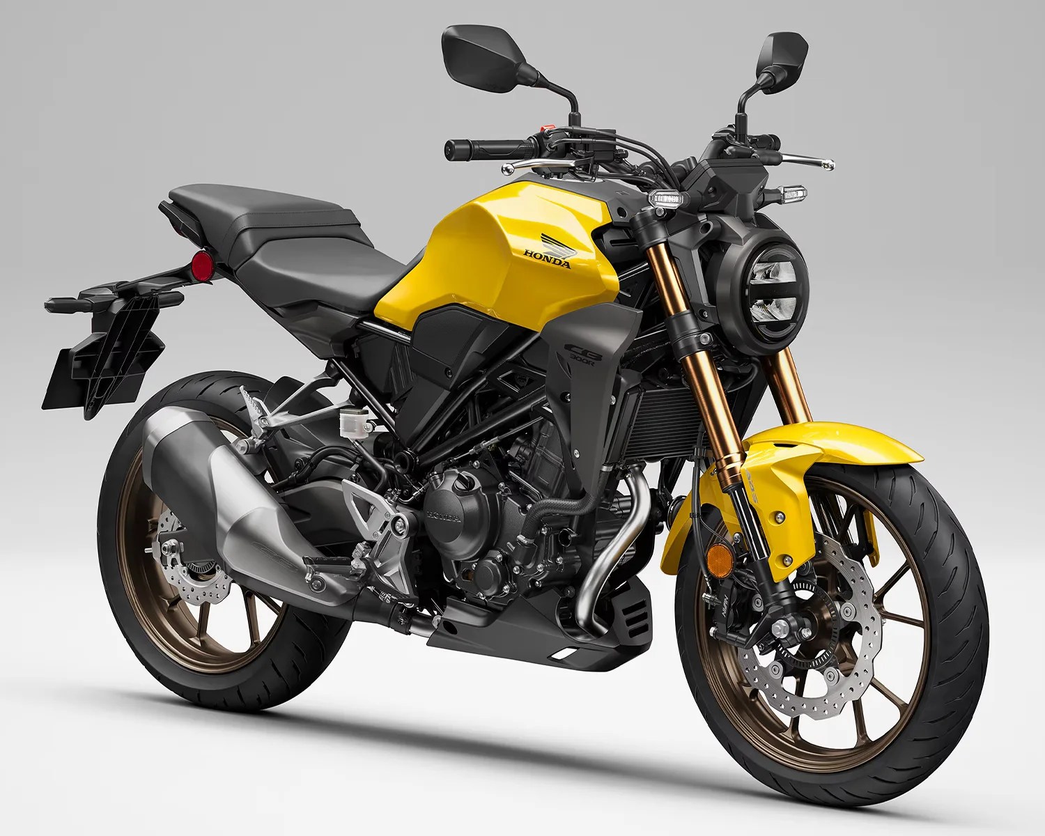 Yellow and black Honda CG 300R motorcycle with bronze wheels on a gray background.