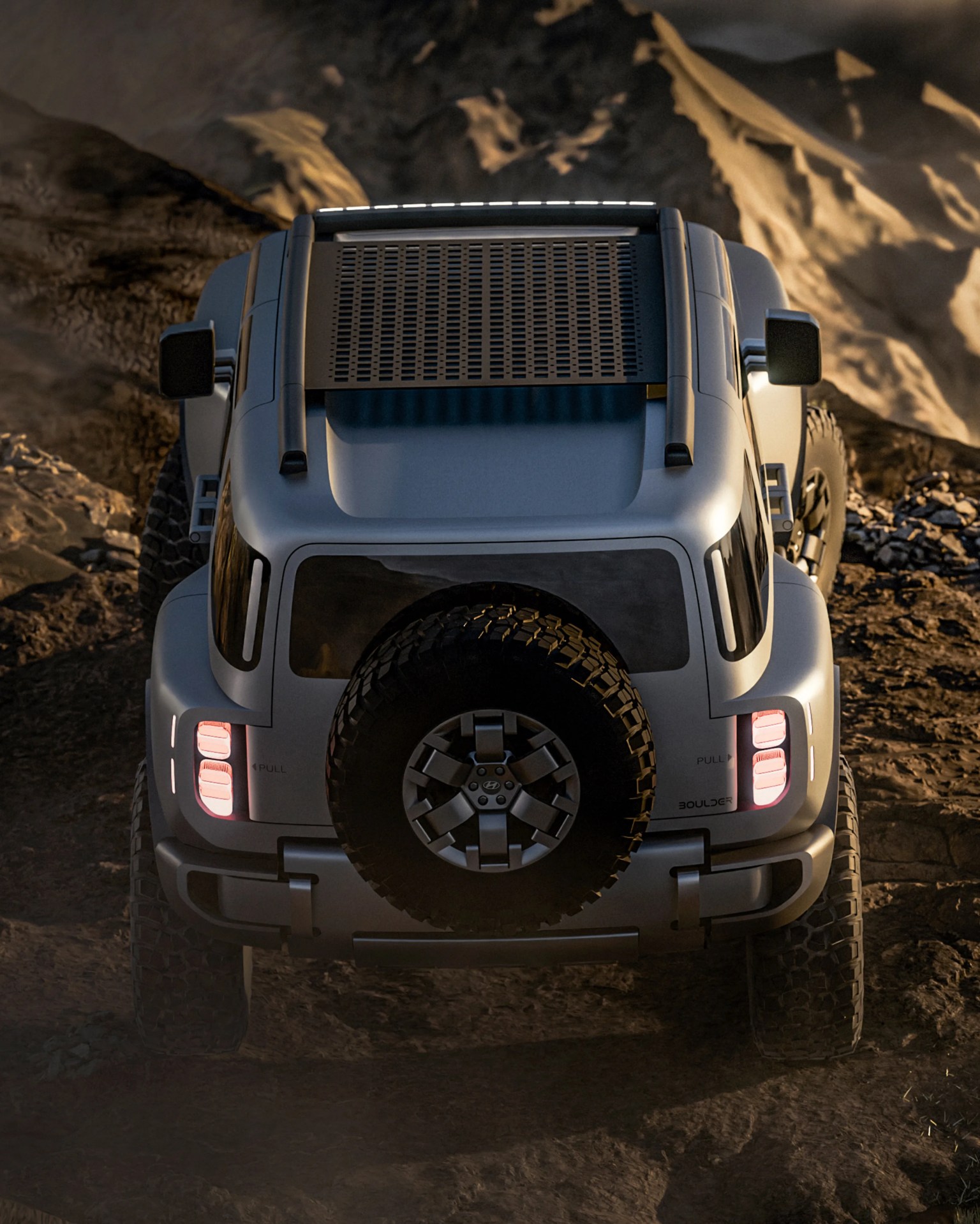 Silver off-road SUV with rear spare tire and illuminated taillights on rocky terrain.