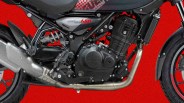 Close-up of a black motorcycle engine and exhaust pipe against a red background.