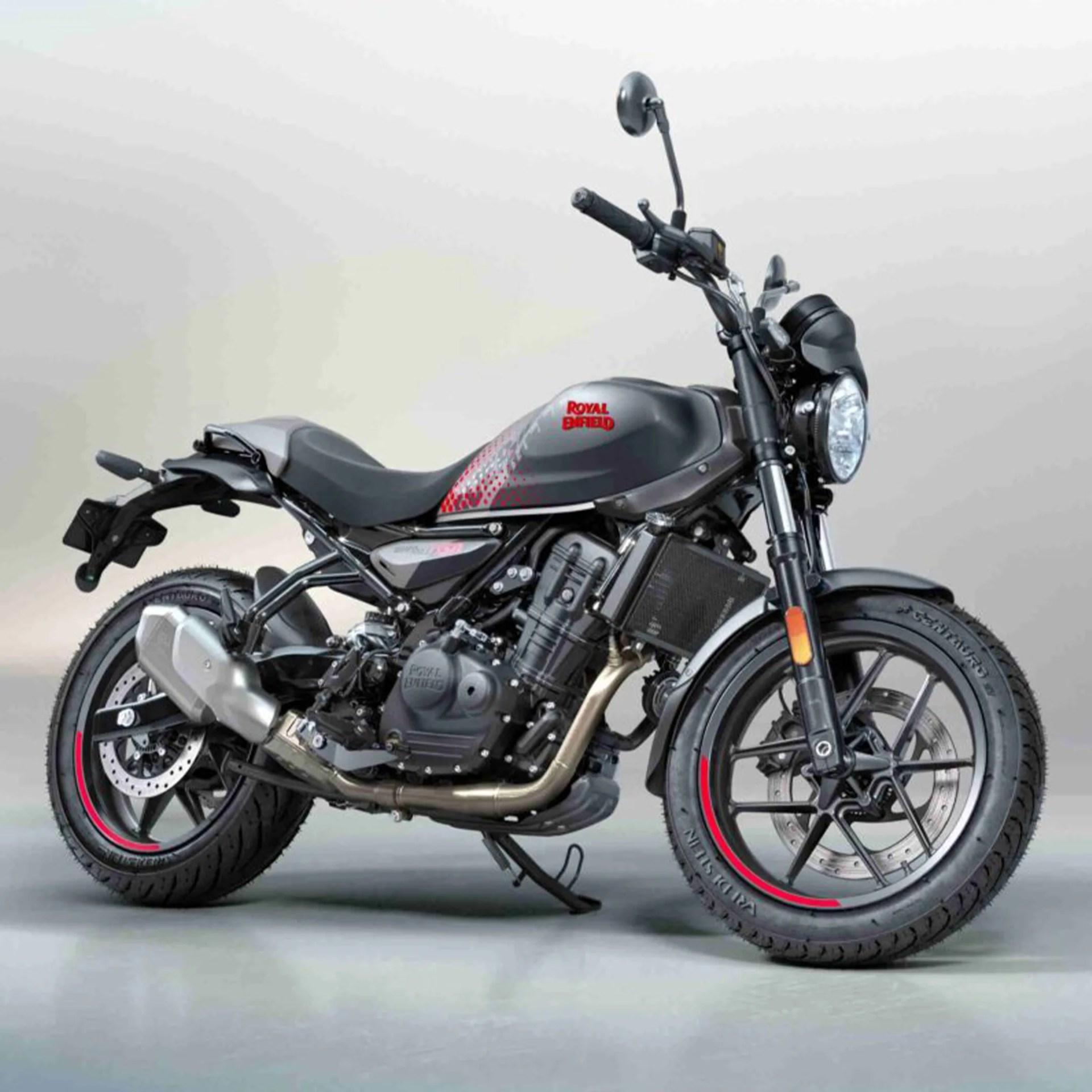 Matte black Royal Enfield motorcycle with red accents and dual disc brakes on a gray floor.