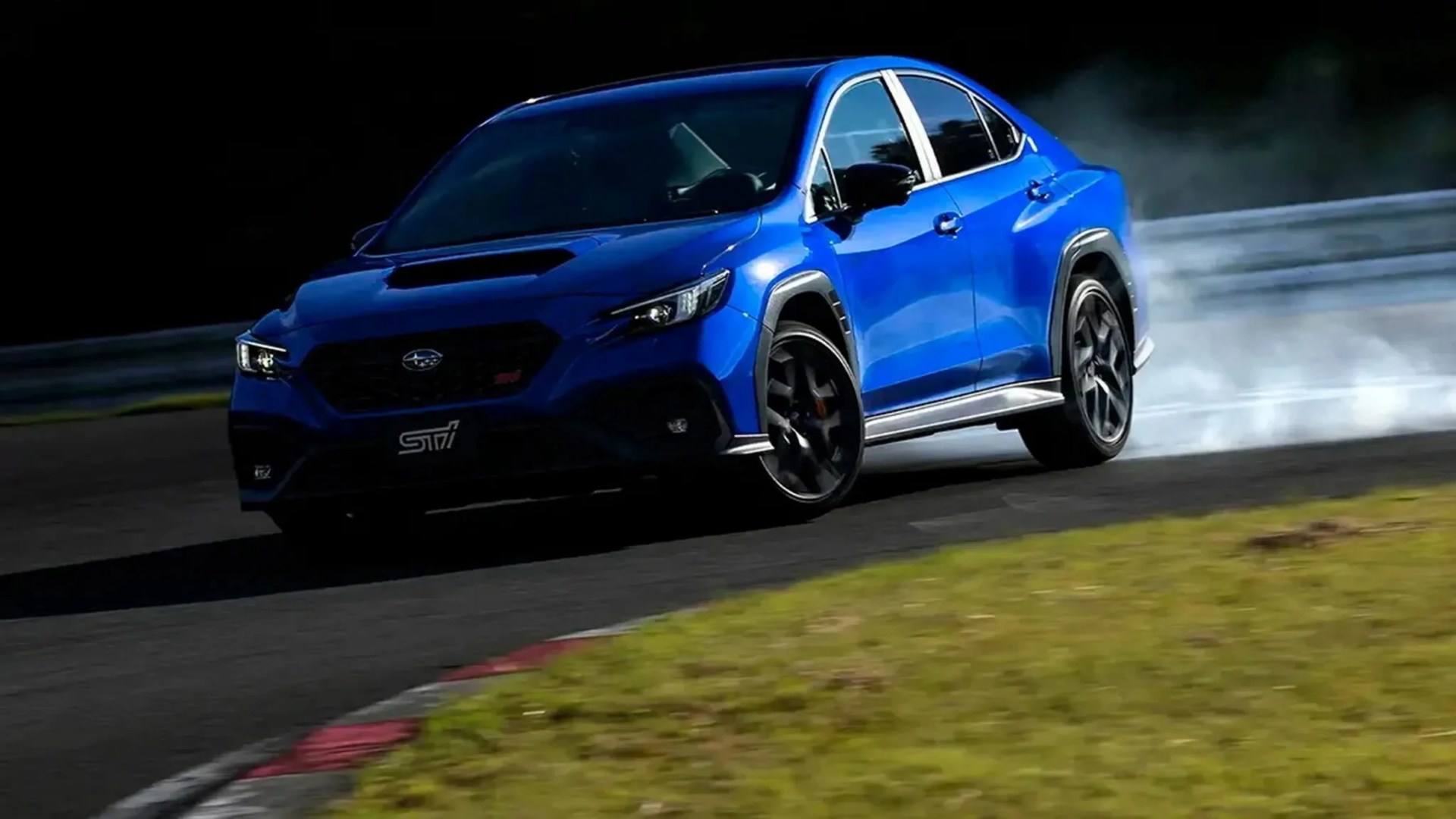 Blue Subaru WRX STI sedan drifting on a racetrack with smoke coming from the rear tires.