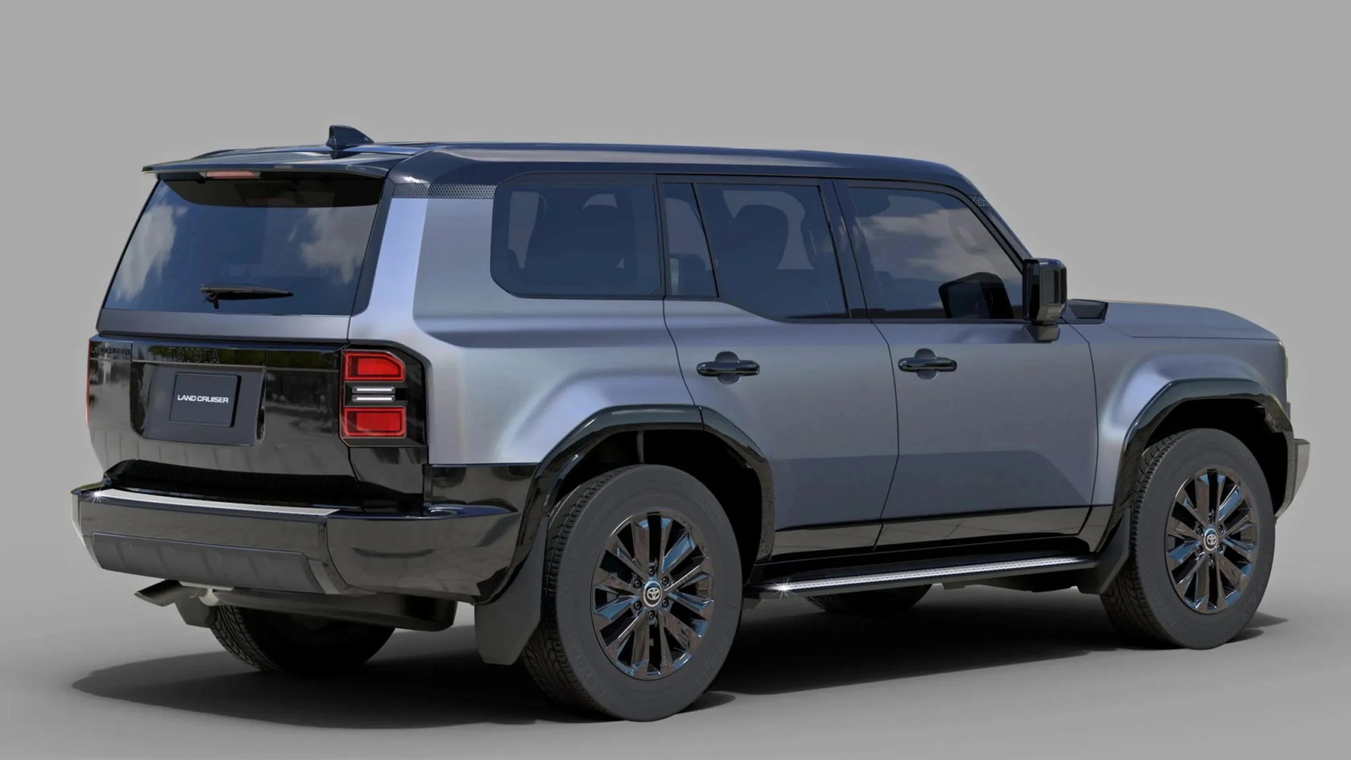 Metallic gray Toyota Land Cruiser SUV with black accents and tinted windows, shown from the rear side.