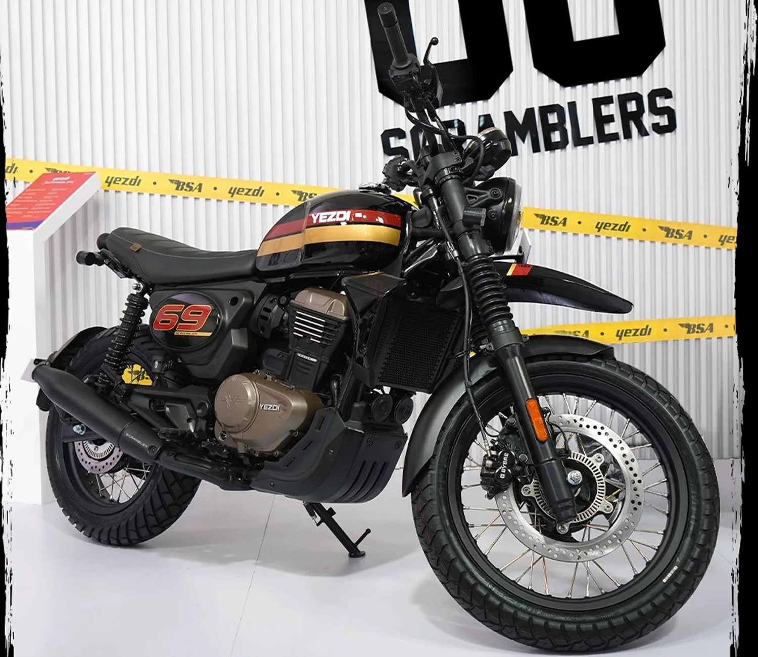 Black and gold Yezdi Scramblers 69 motorcycle with red and yellow stripes on the fuel tank.