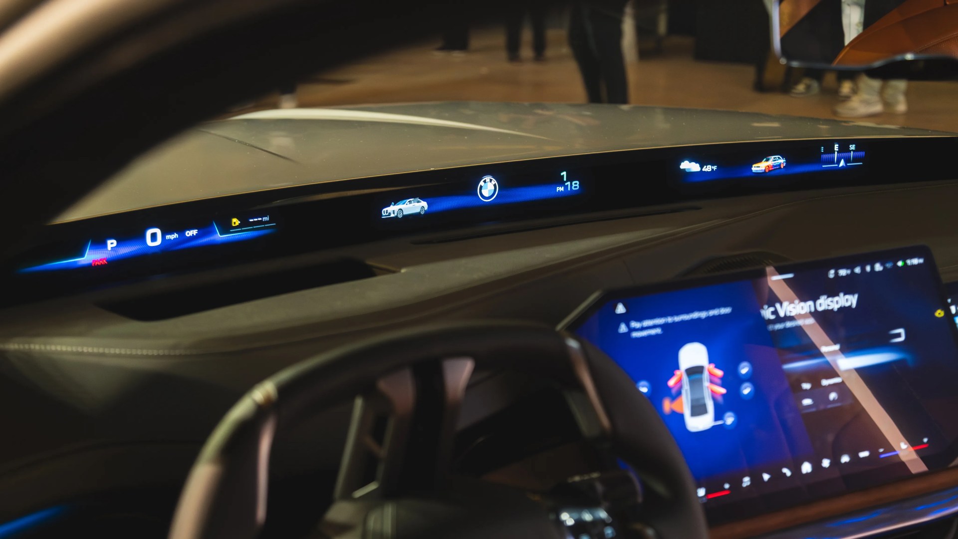 BMW digital dashboard with speedometer, car status, temperature, and navigation display.