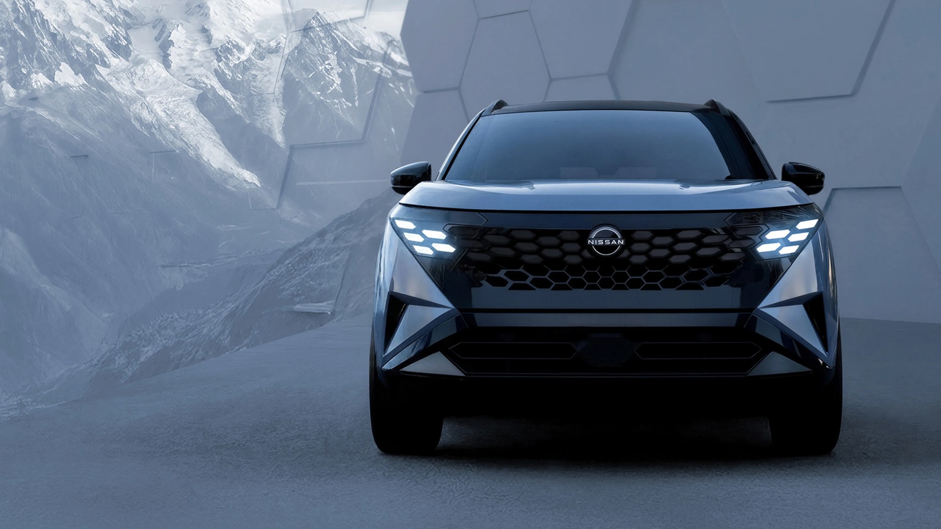 Front view of a black Nissan SUV with illuminated hexagonal LED headlights against a mountainous backdrop.