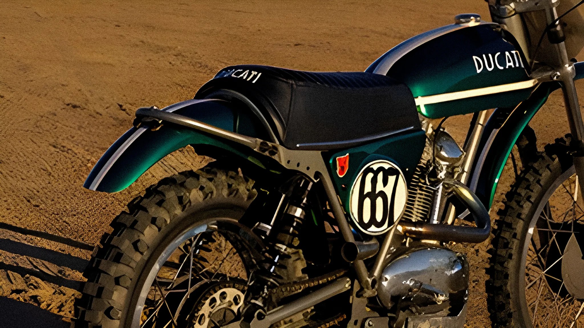 Green and black Ducati dirt bike with knobby tires on a dirt surface.