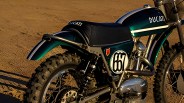 Green and black Ducati dirt bike with knobby tires on a dirt surface.