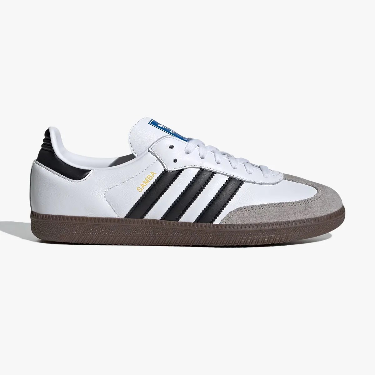 White Adidas Samba sneaker with black stripes, gray suede toe, and brown gum sole.